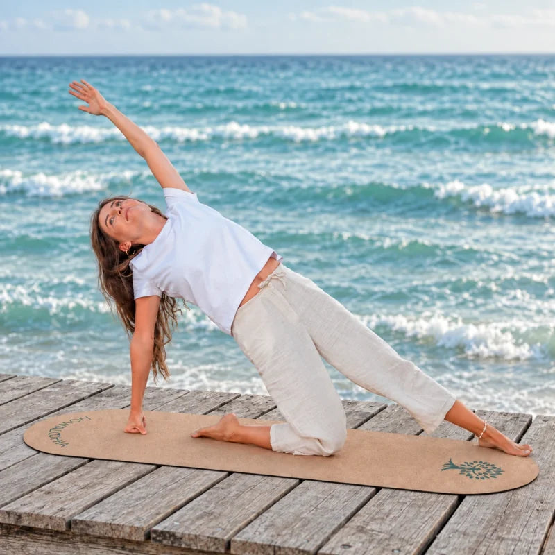 Kalea bei einer Yogaübung am Meer – grünes Logo